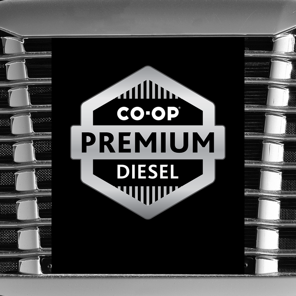 A silver Co-op Premium Diesel logo is featured on a black background. Decorative metal tines frame the logo.